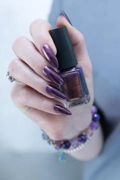 Woman's hand with long nails and multicolored nail polish, blue and brown Stock Photos
