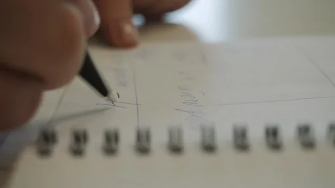 A woman's hand makes notes in a notebook. Stock Footage 140908783