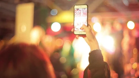 Woman's Hand Makes a Shot on a Smart-phone of the Music Show. Stock Footage 75614143
