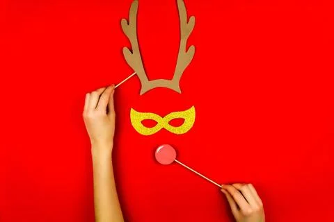 Woman's hand making flat designed funny decorating santa's christmas deer wit Stock Photos