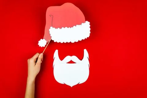 Woman's hand making flat designed funny comic Santa with red Santa's hat, San Stock-Fotos