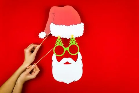 Woman's hand making flat designed funny comic Santa with red Santa's hat, San Stock Photos