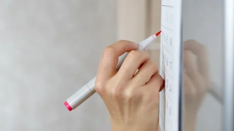 The woman's hand marks the date on the calendar. Planning or deadline concept. Stock Footage 221100866
