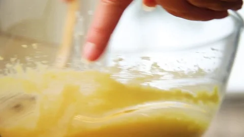 Woman's hand mixing batter in kitchen Vídeos de archivo 76099591