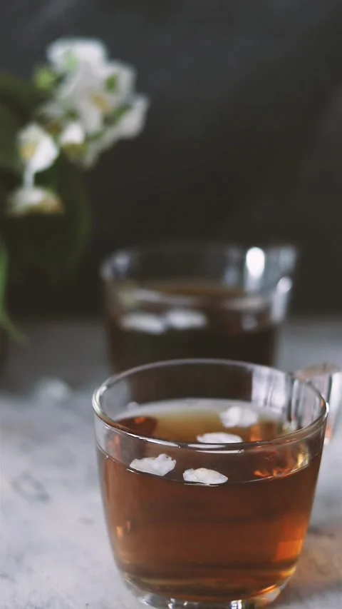 A woman's hand moves tea cups on the table Stock Footage 156207675