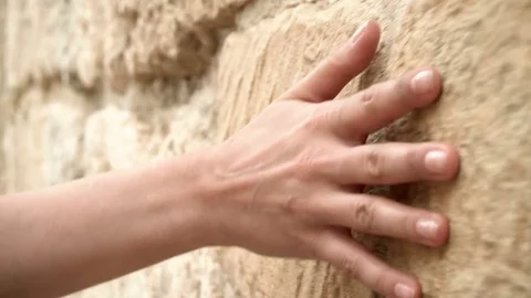 Woman's hand moving over old stone wall. Sliding along. Sensual touching. Hard Stock Footage 73901192
