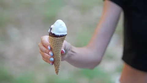 Woman's hand offering ice cream cone to man's hand Stock Footage 340921471