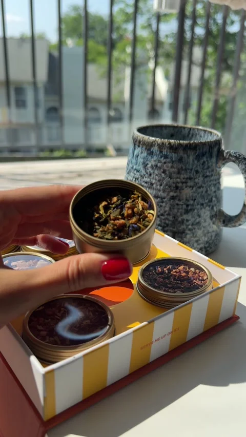 Woman’s hand opening a jar of dried fruit tea and tasting the tea pieces Stock Footage 342072139