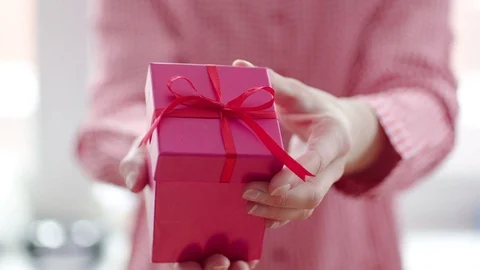 Womans hand opening red gift box with red ribbon Stock Footage 71613179
