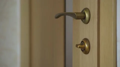 Woman's hand opens and closes the door to lock the house close up Stock Footage 153555209