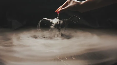 Woman's hand opens and closes an alladin lamp with smoke Stock Footage 224336752