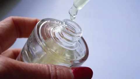 A woman's hand opens and takes out a face serum. Stock Footage 299893104