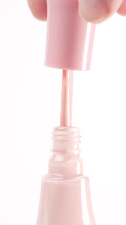 Woman's hand opens a bottle of nail polish Stock Footage 303566153