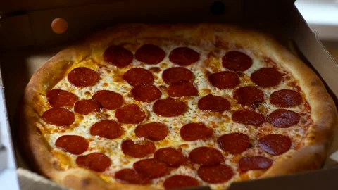 A woman's hand opens a box of Pepperoni pizza inside Stock Footage 272750815