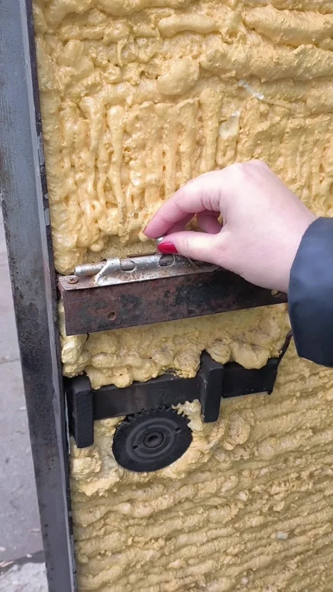 A womans hand opens, closes an old metal latch on the door close-up. Spindle for Stock Footage 322733280