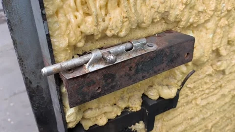 A womans hand opens, closes an old metal latch on the door close-up. Spindle for Stock Footage 322733429