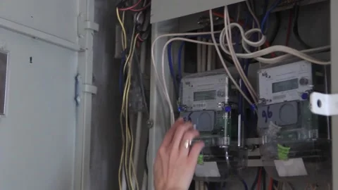 A woman's hand opens a control room with an electric brush and takes readings. Stock Footage 169801973