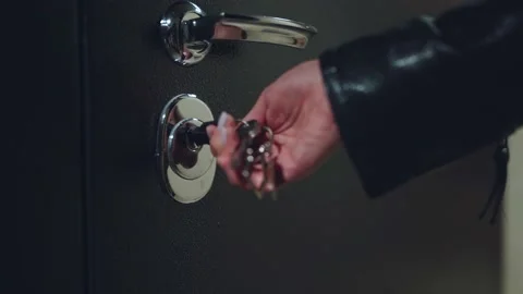 A woman's hand opens the door with a key Stock Footage 219514457