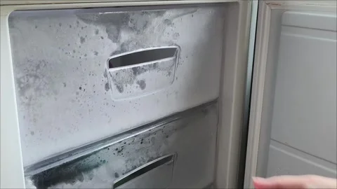 A womans hand opens the freezer door in the refrigerator and pulls out a Vídeo Stock 313834232