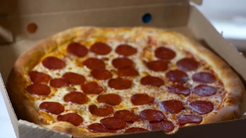 A woman's hand opens, holding and close a box of Pepperoni pizza Stock Footage 270758495