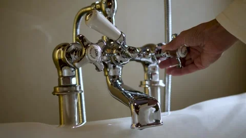 Woman's hand opens the hot and cold water tap for bathing water Stock Footage 262752016