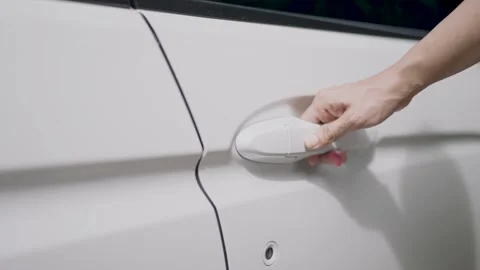 Woman's hand opens white car door. Woman opens car door. Business woman opening  Stock Footage 252733954