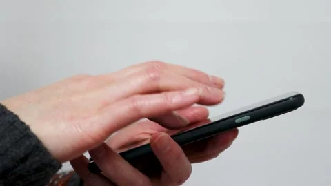 Woman's hand operating a smartphone Stock Footage 234282125