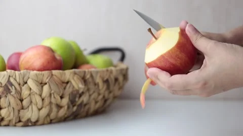 Woman's hand peels an apple Stock Footage 154984961