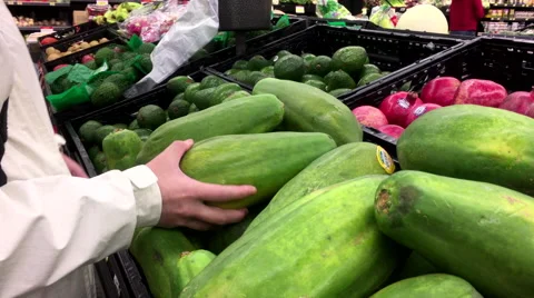 Woman's hand picking papaya inside Walmart store Stock Footage 68361842