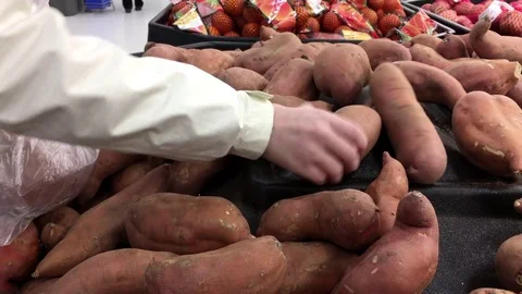Woman's hand picking yam inside Walmart store with 4k resolution Video stock 72251327