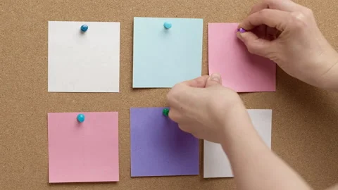 A woman's hand pins blank notes on a corkboard. Concept for business ideas Stock Footage 231806023