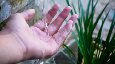 Woman's hand is playing and scooping water in a clean river. Hand scooping Stock Footage 270319688