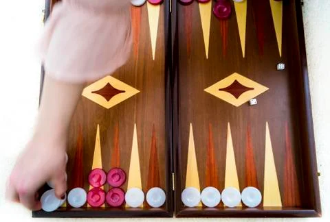 Woman's hand playing backgammon Stock Photos
