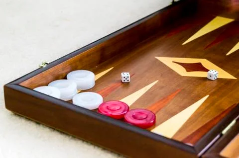 Woman's hand playing backgammon Stock Photos