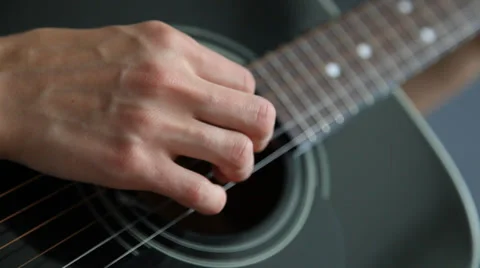 Woman’s hand playing on a guitar Stock Footage 30382208