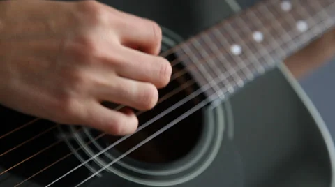 Woman’s hand playing on a guitar Stock Footage 30383733