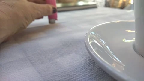 Woman's hand playing with lighter on table Stock Footage 308304530