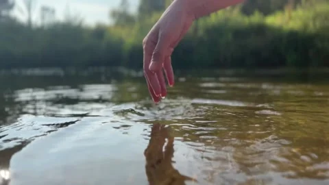 Woman's hand playing in the water Stock Footage 282829451