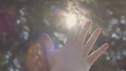 Woman's Hand Plays With Sunlight Between Fingers, Lens Flare Stock-Footage 129410253