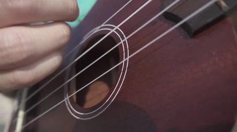Woman's Hand Plays Ukulele. Close Deck View. Slow Motion Stockbeeldmateriaal 67216255