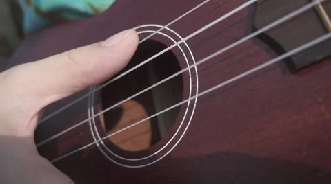 Woman's Hand Plays Ukulele. Close Deck View. Slow Motion Stock Footage 67217216