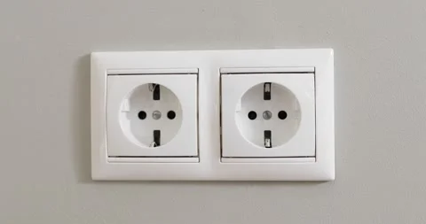 Woman's hand plugging white power plug into white multiple socket indoors. Stock Footage 156773745