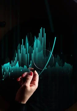A woman's hand points to neon binary charts and growth graphs Foto stock