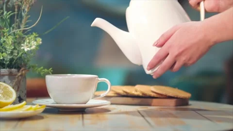 Woman's hand pouring tea Stock Footage 137225549