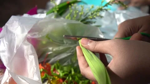 A woman's hand preparing flowers to pay respect to the monks. Stock Footage 140390370
