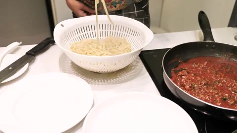 A woman's hand preparing pasta on the kitchen table. Close up shot. Stock Footage 164834960