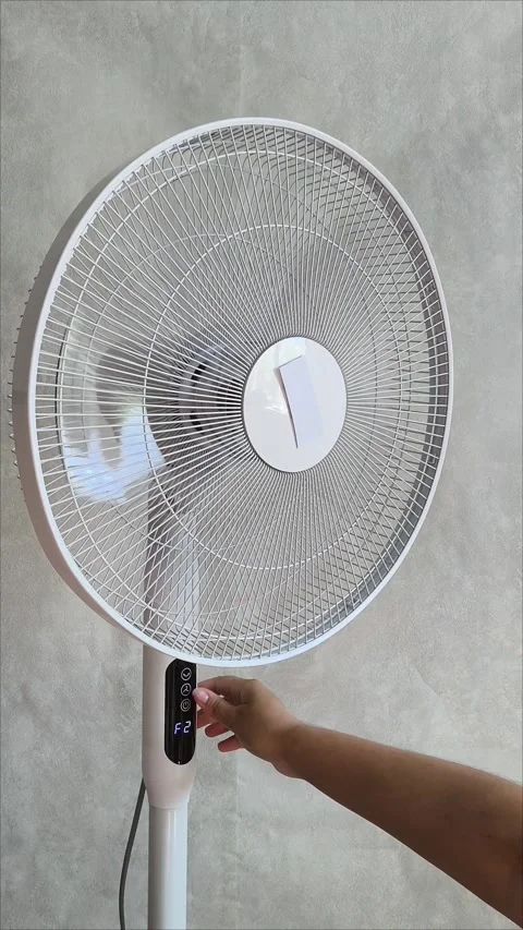 A womans hand presses the ventilator switch in a room on a gray background Stock Footage 313521395