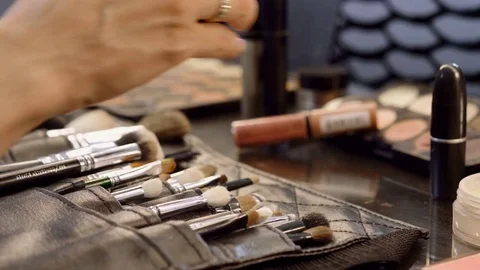 Woman's hand pulling brushes out of a set with instruments for make up. 4K Stock Footage 80436786