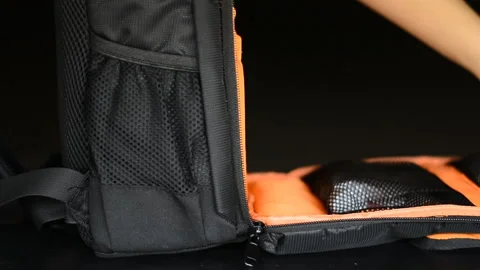 Womans hand pulling zipper of cameras bag to close Stock Footage 132610359