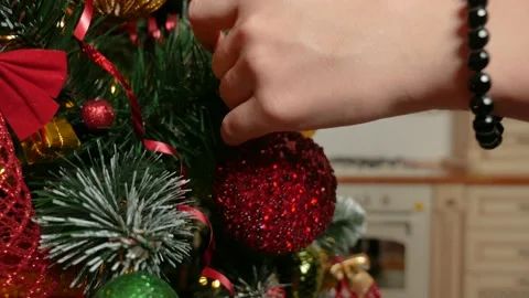 Woman's hand put on christmas tree red ball Stock Footage 165538581